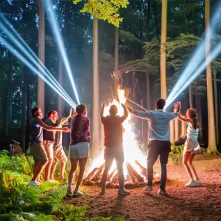 People dancing at night in coloured light